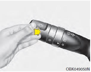 To turn on the high beam headlights, push the lever away from you. Pull it back