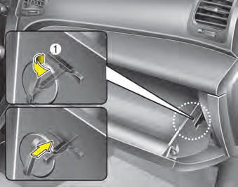 1. Open the glove box and remove the support strap (1).