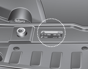 The refrigerant label is located at the front of the engine room.